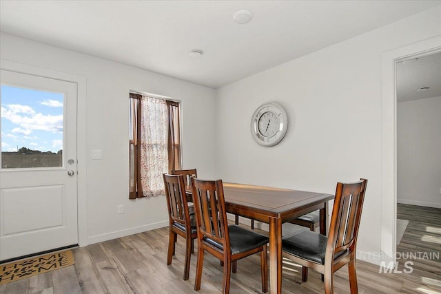 dining room with light wood finished floors and baseboards