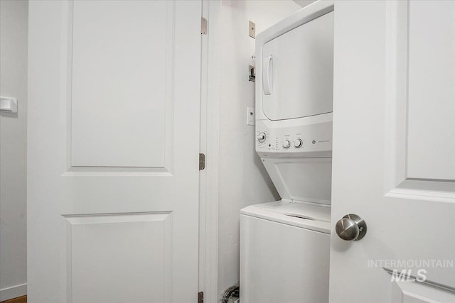 laundry area featuring stacked washer / dryer