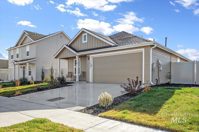 view of front of property with board and batten siding, a garage, driveway, and a porch