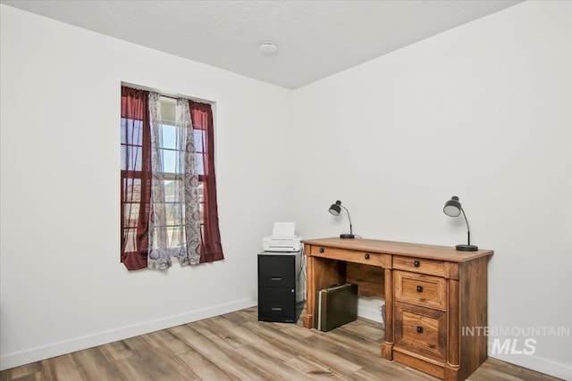 home office featuring wood finished floors and baseboards