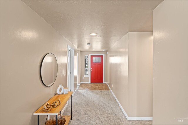 6296 W Mattawa Dr, Meridian, ID 83646 - doorway with baseboards, carpet flooring, and a textured ceiling