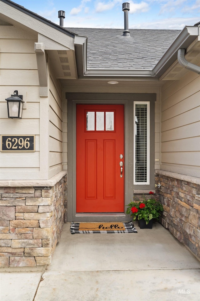 6296 W Mattawa Dr, Meridian, ID 83646 - property entrance with a shingled roof and stone siding