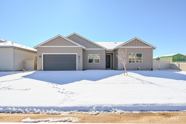 view of front of house with a garage, fence, and board and batten siding