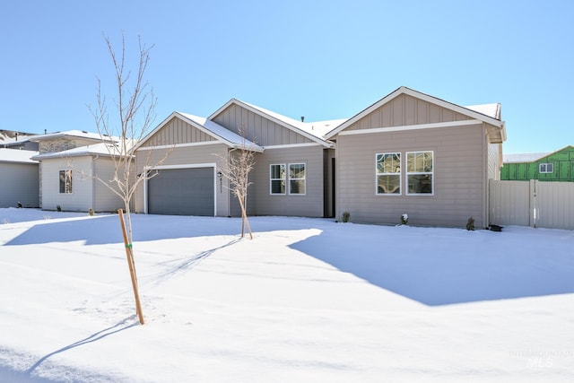 view of front of home featuring a garage, a gate, fence, and board and batten siding