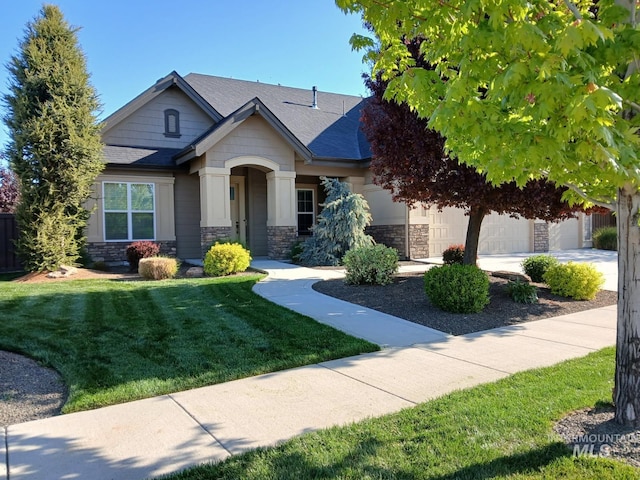 4234 W Wolf Rapids St, Meridian, ID 83646 - craftsman-style house with stone siding, a garage, a front lawn, and roof with shingles
