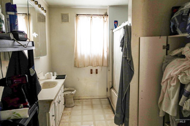 full bath featuring visible vents, bath / shower combo with glass door, toilet, tile patterned floors, and vanity