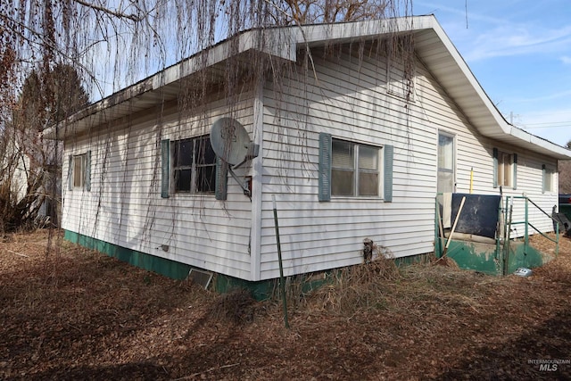 view of side of property with crawl space