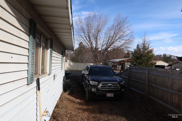 view of side of home featuring fence