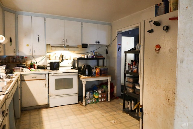 kitchen with light floors, white electric stove, white cabinets, and light countertops