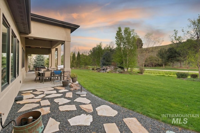 421 E Fishing Creek Ln, Eagle, ID 83616 - yard at dusk with a patio area, a yard, and outdoor dining area