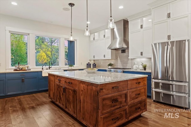 421 E Fishing Creek Ln, Eagle, ID 83616 - kitchen featuring stainless steel appliances, wall chimney exhaust hood, a sink, white cabinetry, and recessed lighting