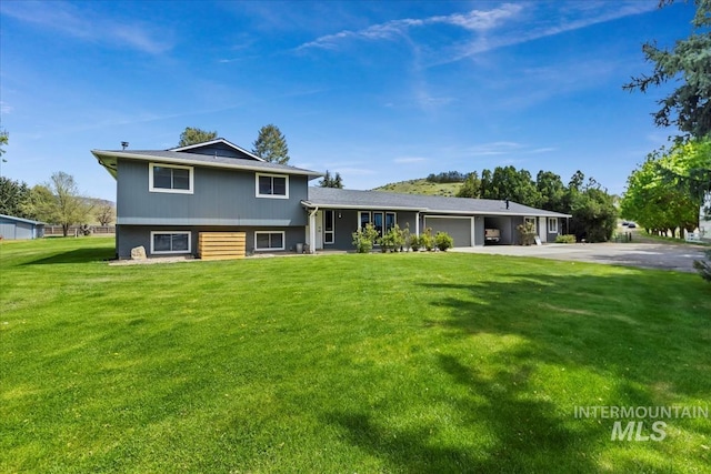 13343 N Horseshoe Bend Rd, Boise, ID 83714 - split level home featuring a garage, concrete driveway, and a front yard