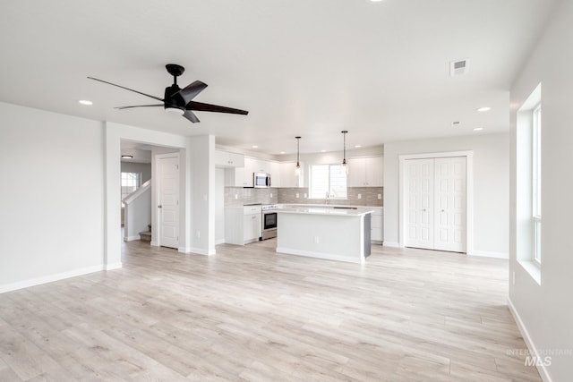 unfurnished living room featuring recessed lighting, light wood-style floors, and visible vents