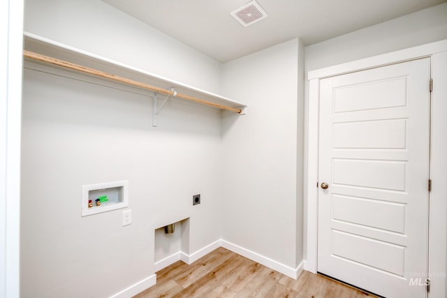 washroom with electric dryer hookup, visible vents, light wood-style flooring, hookup for a washing machine, and laundry area