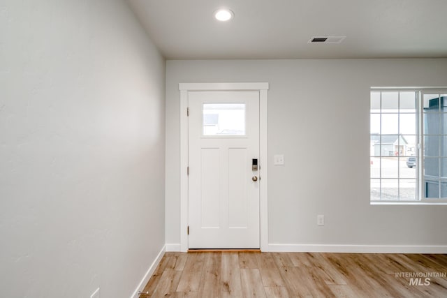 entryway featuring visible vents, light wood-style flooring, and baseboards