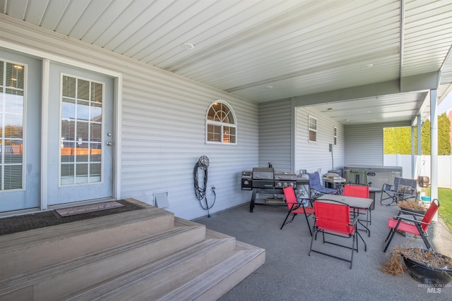 view of patio with outdoor dining space and fence