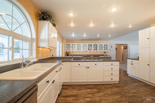 kitchen featuring gas stovetop, white cabinetry, dark wood-style flooring, and a sink