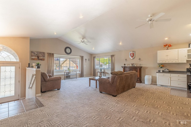 living area featuring light tile patterned floors, a ceiling fan, light carpet, vaulted ceiling, and baseboards