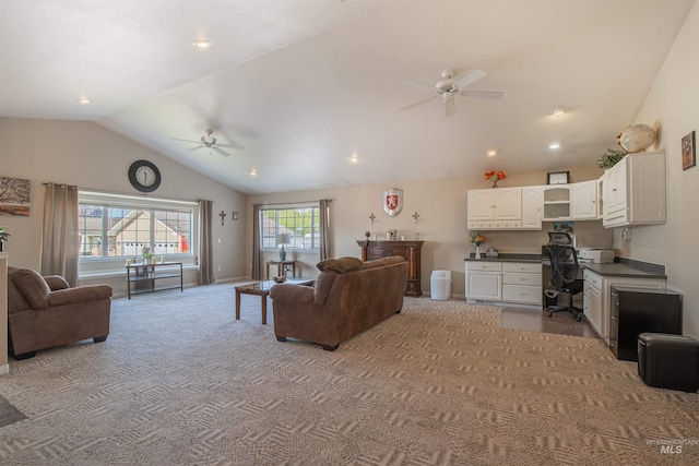 carpeted living area with lofted ceiling, ceiling fan, baseboards, and built in study area