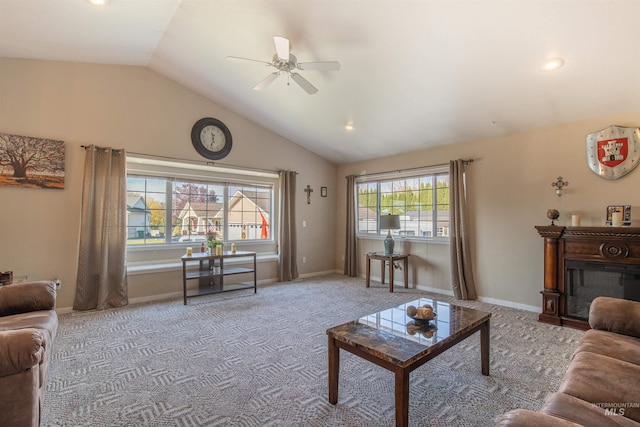 living area featuring baseboards, lofted ceiling, ceiling fan, carpet, and a fireplace