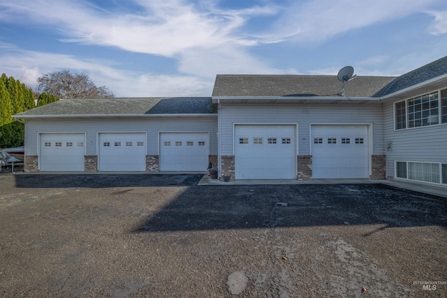 garage with aphalt driveway