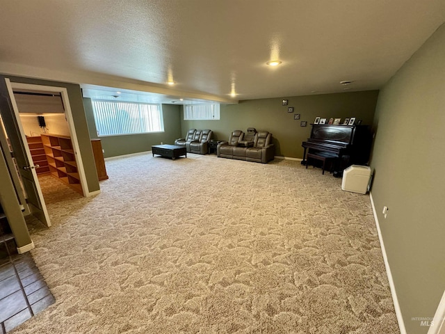 carpeted living room featuring a textured ceiling and baseboards