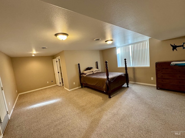 carpeted bedroom with a textured ceiling and baseboards