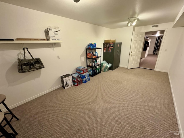 interior space featuring carpet floors, visible vents, and baseboards