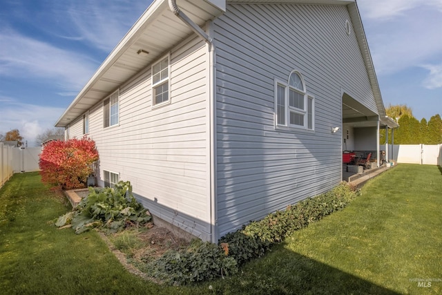 view of side of property with a fenced backyard and a yard