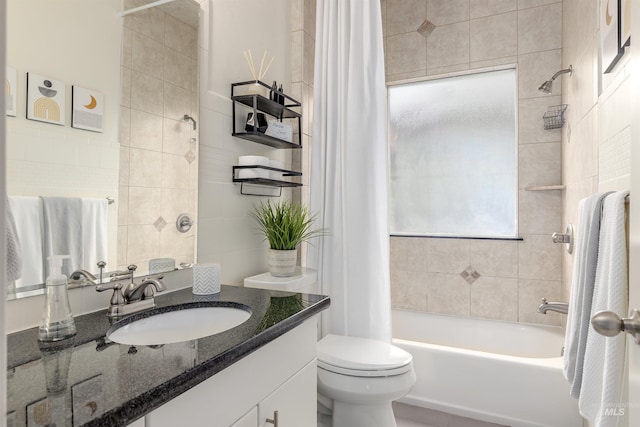 bathroom featuring shower / bath combo with shower curtain, toilet, tile walls, and vanity