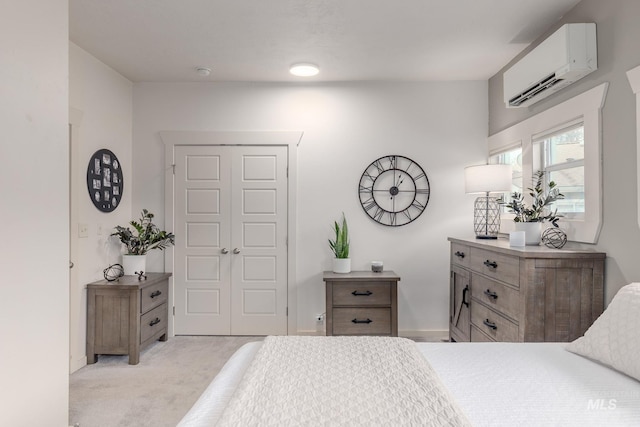 bedroom featuring light carpet, a closet, and a wall unit AC