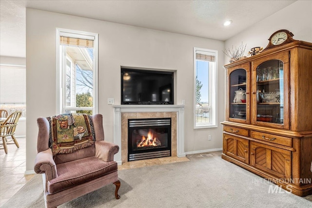 sitting room with light carpet and a fireplace