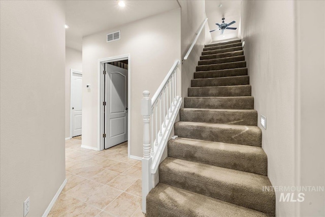 staircase featuring ceiling fan