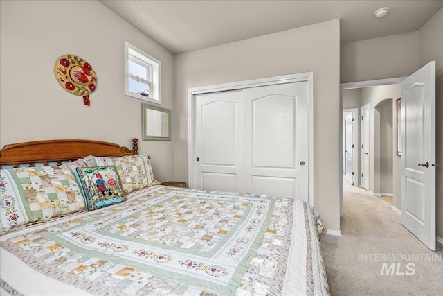 carpeted bedroom featuring a closet