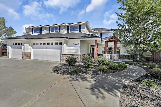 5278 N Cougar Flat Pl, Meridian, ID 83646 - view of front of house with stone siding, driveway, fence, and an attached garage