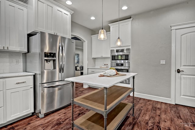 5278 N Cougar Flat Pl, Meridian, ID 83646 - kitchen with decorative light fixtures, dark wood finished floors, white cabinetry, stainless steel appliances, and tasteful backsplash