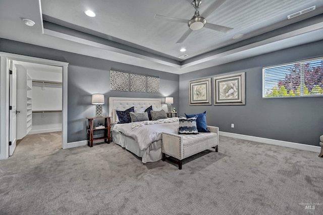 5278 N Cougar Flat Pl, Meridian, ID 83646 - bedroom with a ceiling fan, carpet floors, visible vents, baseboards, and a raised ceiling
