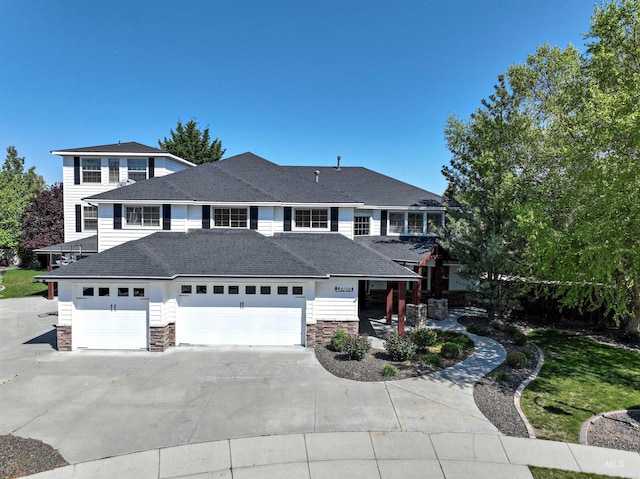 5278 N Cougar Flat Pl, Meridian, ID 83646 - prairie-style home with concrete driveway, stone siding, a shingled roof, and an attached garage