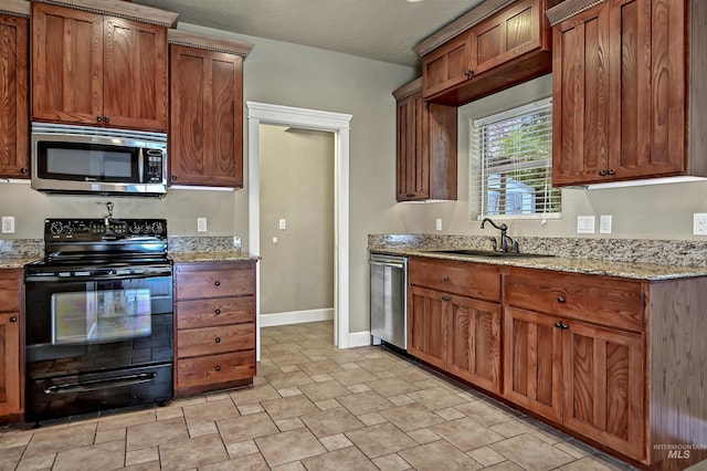 5278 N Cougar Flat Pl, Meridian, ID 83646 - kitchen featuring a sink, stainless steel appliances, brown cabinets, light stone counters, and baseboards