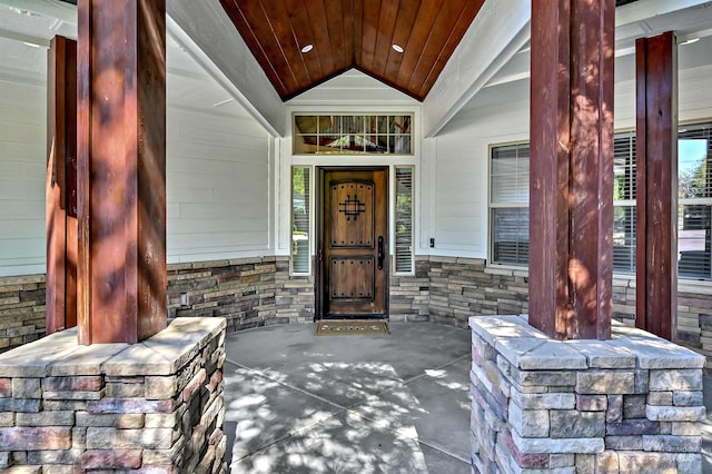 5278 N Cougar Flat Pl, Meridian, ID 83646 - doorway to property featuring stone siding and covered porch