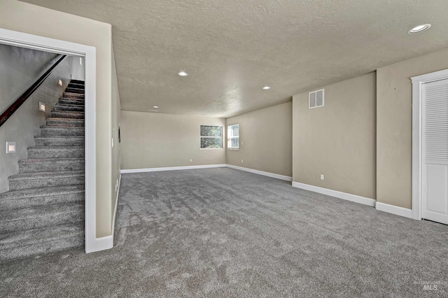 5278 N Cougar Flat Pl, Meridian, ID 83646 - below grade area with recessed lighting, a textured ceiling, carpet flooring, visible vents, and stairs