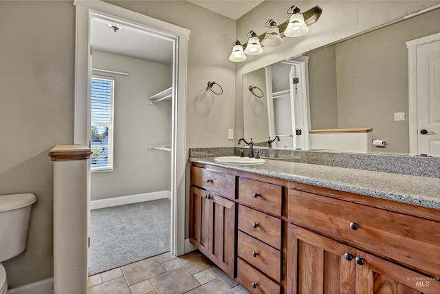 5278 N Cougar Flat Pl, Meridian, ID 83646 - full bathroom featuring vanity, toilet, and baseboards