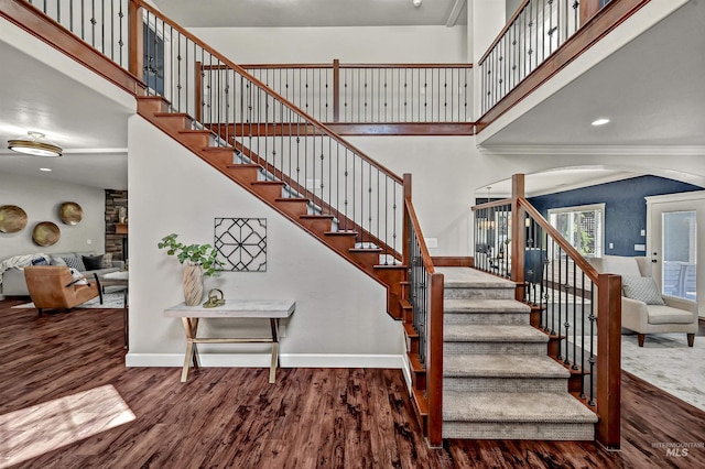 5278 N Cougar Flat Pl, Meridian, ID 83646 - staircase with a high ceiling, wood finished floors, baseboards, and arched walkways