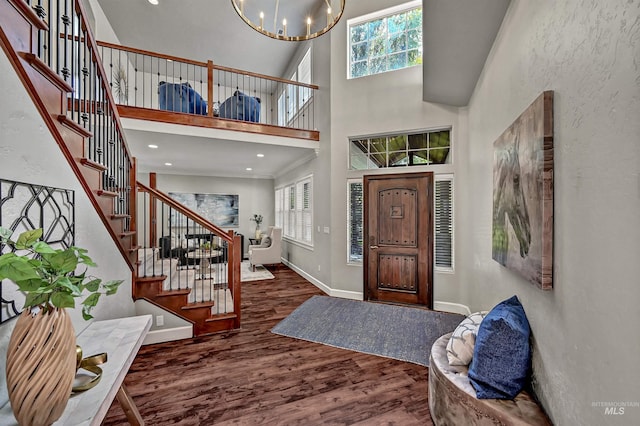 5278 N Cougar Flat Pl, Meridian, ID 83646 - foyer with stairs, wood finished floors, an inviting chandelier, a high ceiling, and baseboards