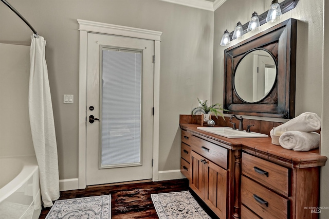 5278 N Cougar Flat Pl, Meridian, ID 83646 - bathroom featuring baseboards, wood finished floors, vanity, and ornamental molding