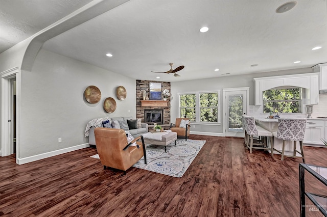 5278 N Cougar Flat Pl, Meridian, ID 83646 - living area with a wealth of natural light, baseboards, a fireplace, and ceiling fan