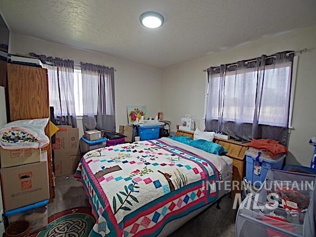 bedroom with carpet floors and a textured ceiling