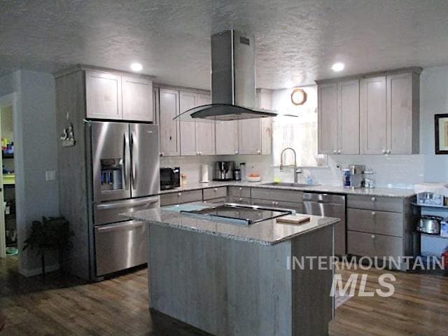 kitchen with sink, hardwood / wood-style flooring, a center island, island range hood, and black appliances