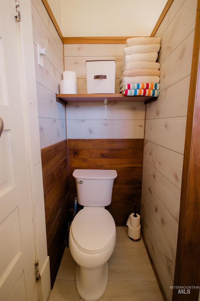 599 S Ada St, Glenns Ferry, ID 83623 - bathroom with wood walls, toilet, and wood finished floors