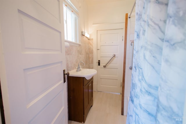 599 S Ada St, Glenns Ferry, ID 83623 - bathroom with vanity, a shower with shower curtain, and tile walls